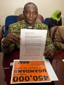 Canon Gideon Byamugisha with Avaaz campaign signatures and a petition calling for rejection of an anti-homosexuality bill. An Anglican priest with a parish outside of Kampala, he was the first religious leader in Africa to publicly announce that he was HIV positive. Photo: James Akena